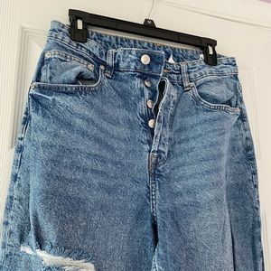 ripped medium wash blue jeans
